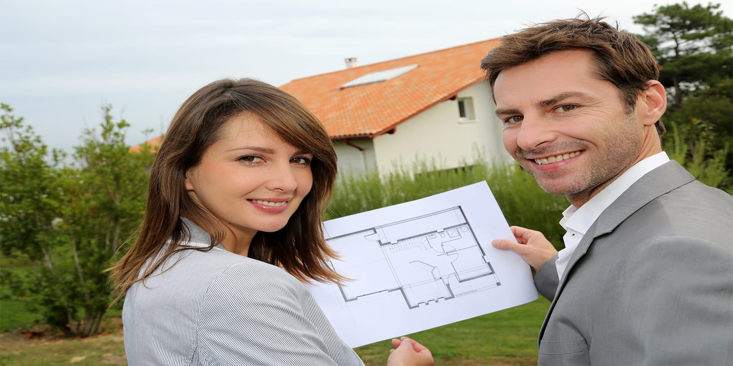 Real estate investor couple looking at house floor plan